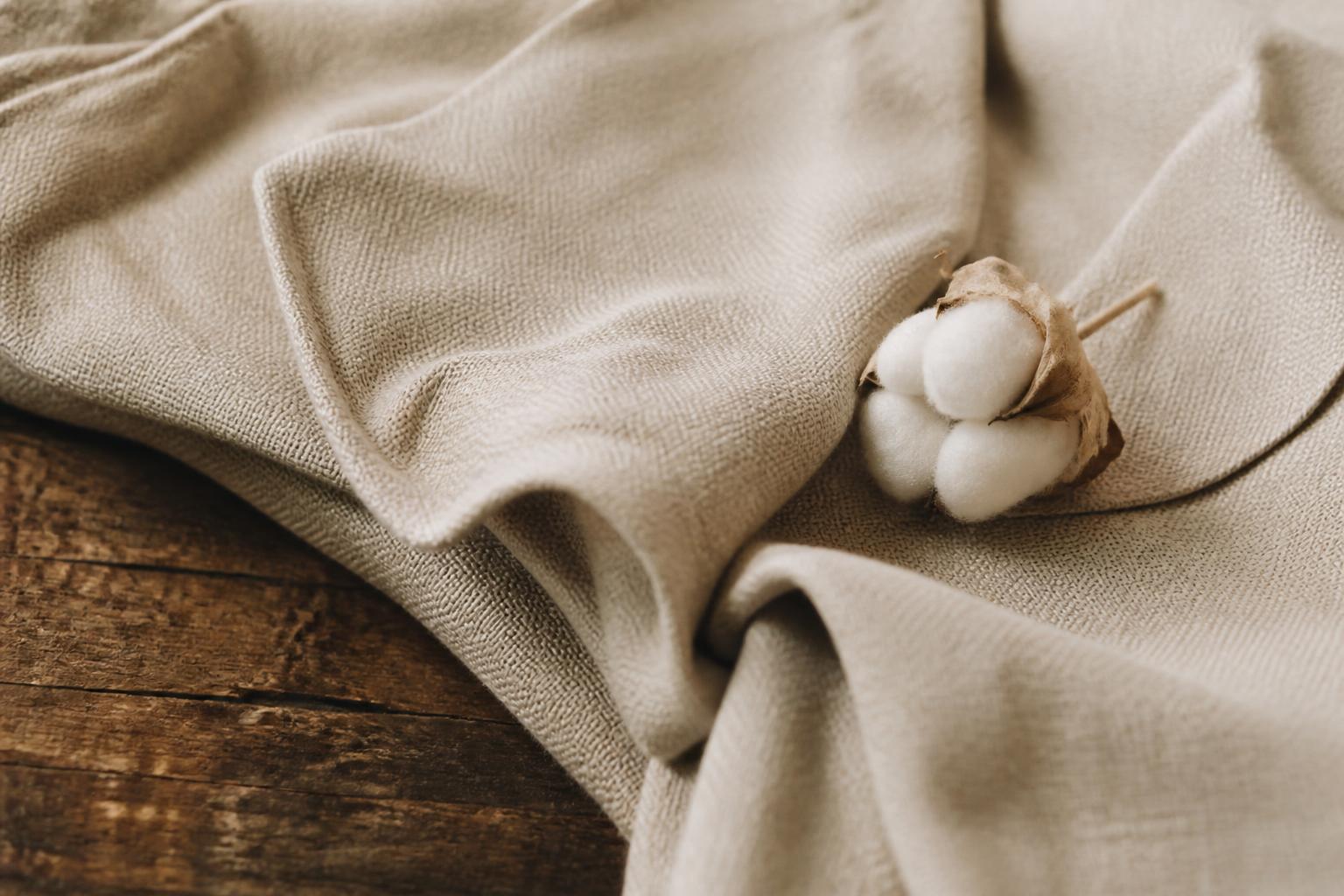 Close-up of a man wearing a beige linen shirt with visible fabric texture against a neutral background